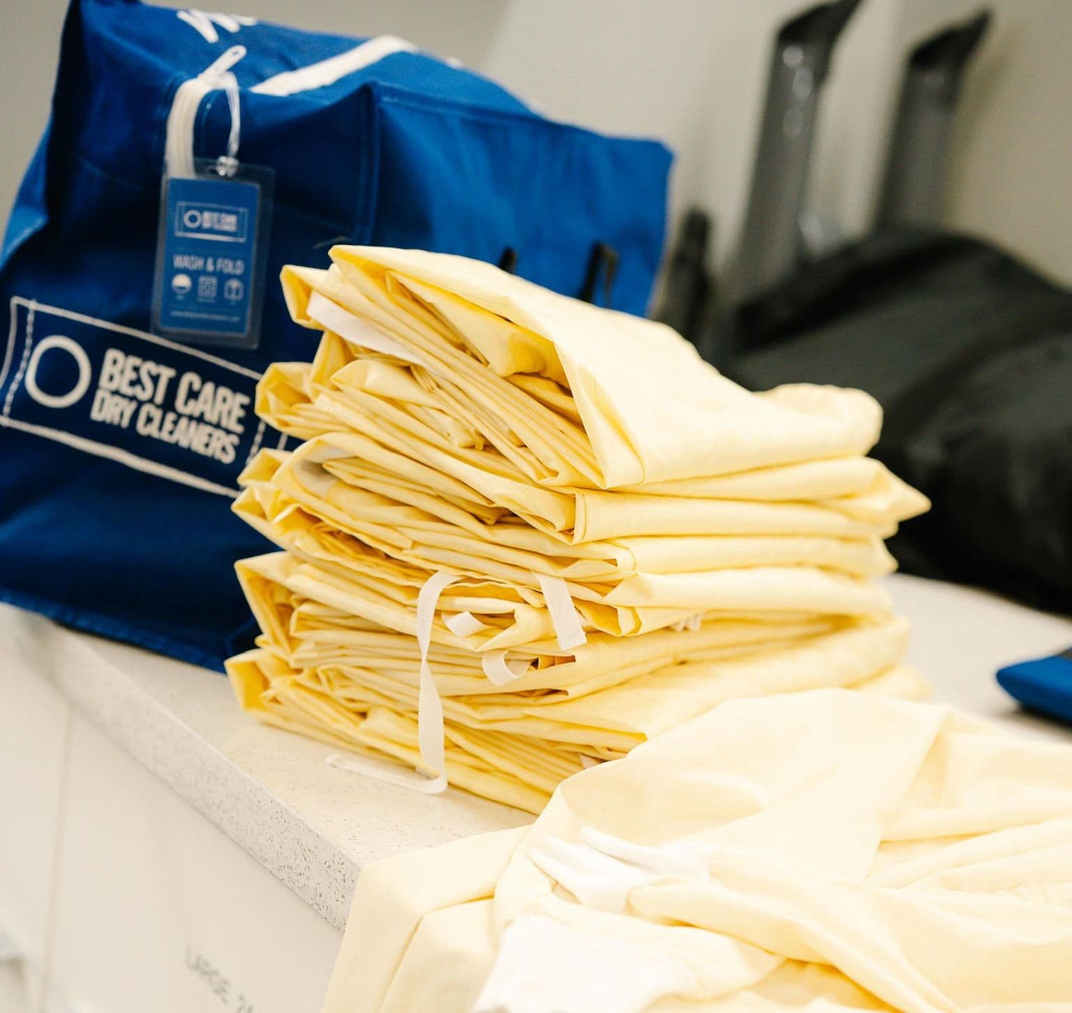 A pile of professionally folded smocks